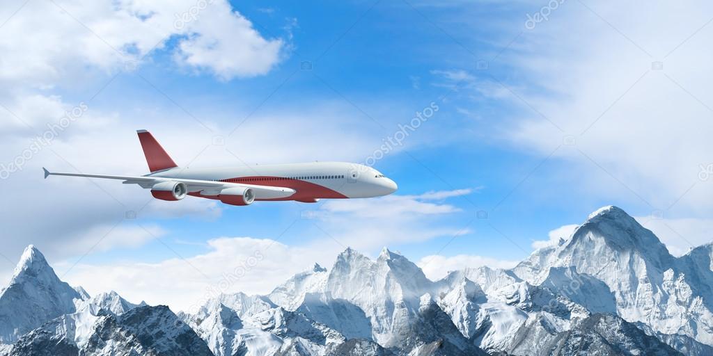 White passenger plane above the mountains