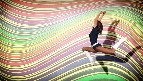 Young woman dancing and jumping... — Stock Photo, Image