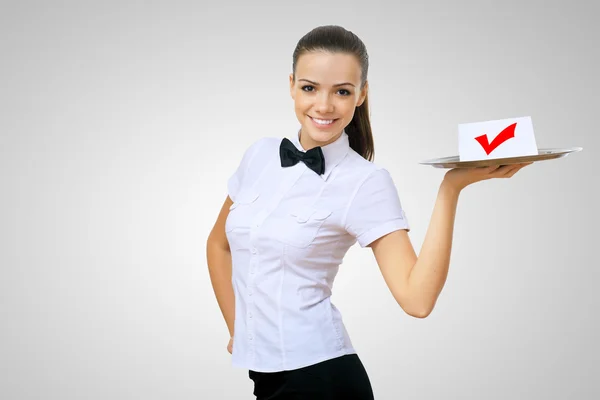 Waitress holding a tray with symbol of success — Stock Photo, Image