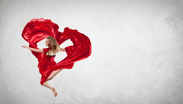 Dancing young woman with flying fabric — Stock Photo, Image