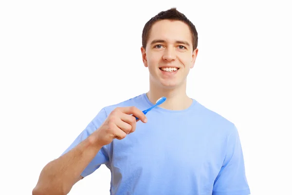 Young man at home brushing teeth — Stock Photo, Image