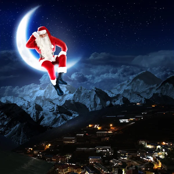 Photo of santa claus sitting on the moon — Stock Photo, Image