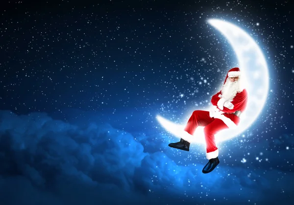 Photo of santa claus sitting on the moon — Stock Photo, Image