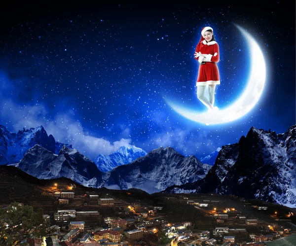 Photo of santa claus sitting on the moon — Stock Photo, Image