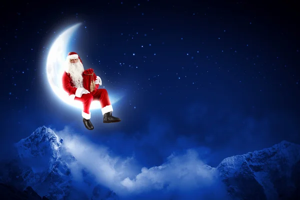 Photo of santa claus sitting on the moon — Stock Photo, Image