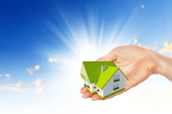 The house in hands on blue sky — Stock Photo, Image