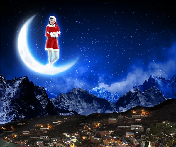 Photo of santa claus sitting on the moon — Stock Photo, Image