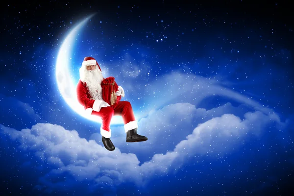 Foto av santa claus sitter på månen — Stockfoto