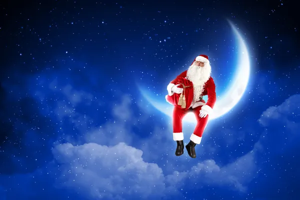 Foto de Papai Noel sentado na lua — Fotografia de Stock