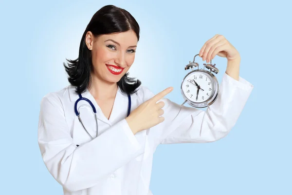 Young female doctor with clocks — Stock Photo, Image