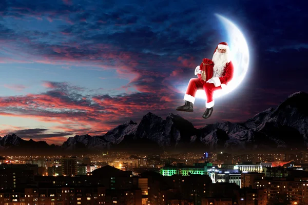 Photo of santa claus sitting on the moon — Stock Photo, Image