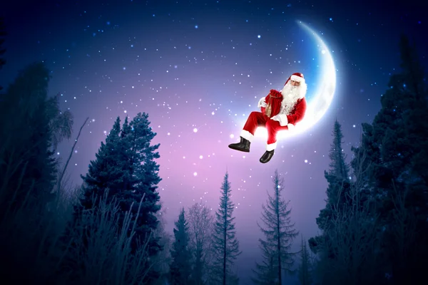 Foto de santa claus sentado en la luna — Foto de Stock