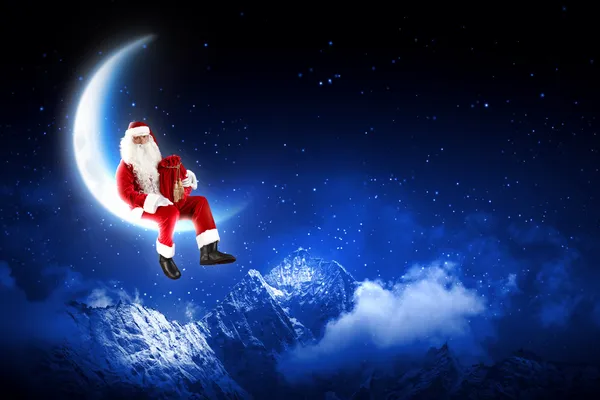 Foto av santa claus sitter på månen — Stockfoto
