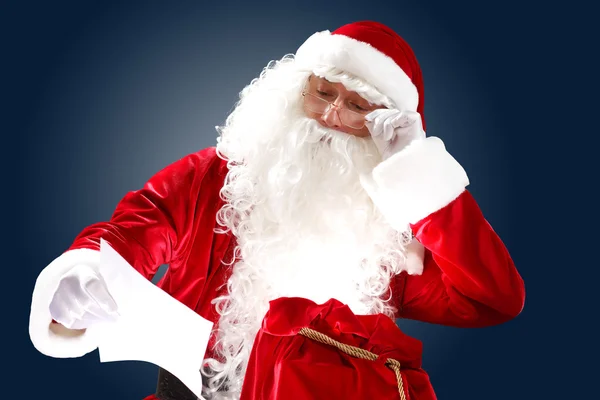 Santa claus reading a letter — Stock Photo, Image