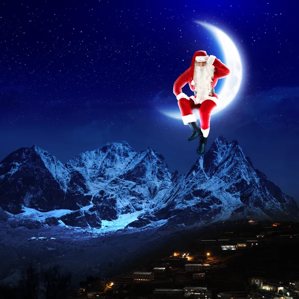 Photo of santa claus sitting on the moon — Stock Photo, Image