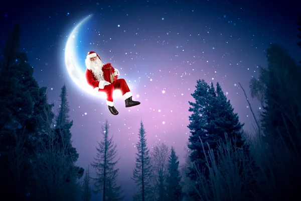 Foto de Papai Noel sentado na lua — Fotografia de Stock