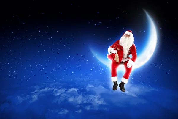 Photo of santa claus sitting on the moon — Stock Photo, Image