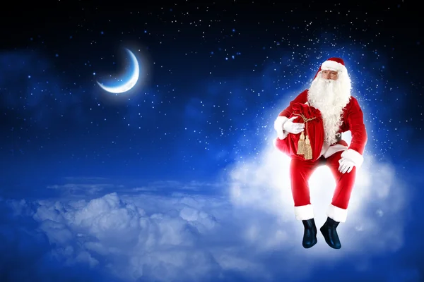 Foto de Papai Noel sentado na lua — Fotografia de Stock