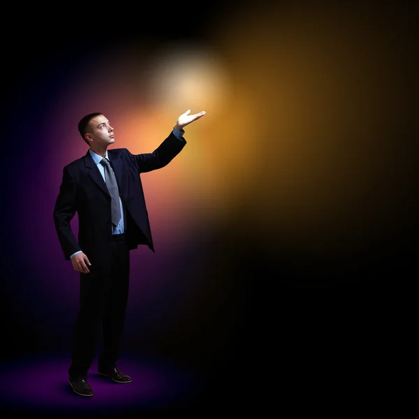 Businessman with light shining — Stock Photo, Image