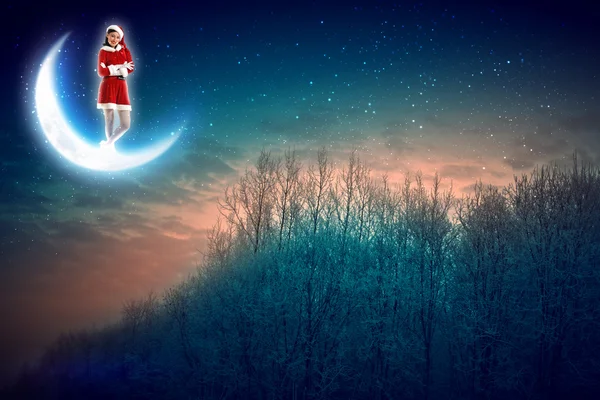 Foto van santa claus zittend op de maan — Stockfoto