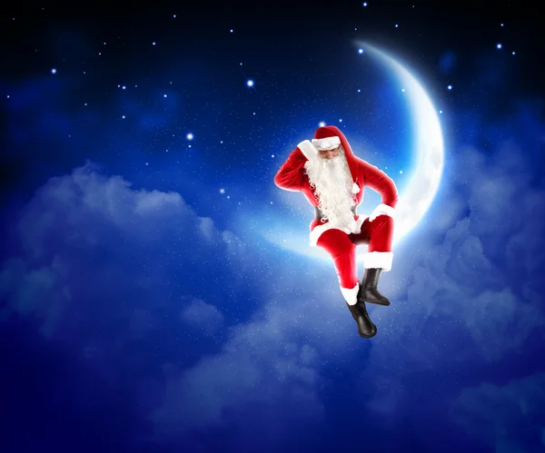 Foto de Papai Noel sentado na lua — Fotografia de Stock