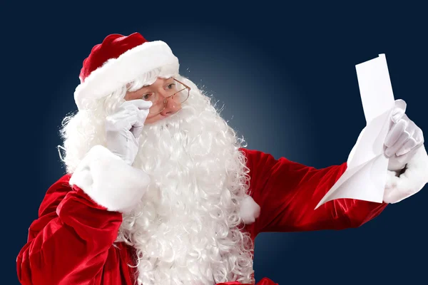 Santa claus reading a letter — Stock Photo, Image