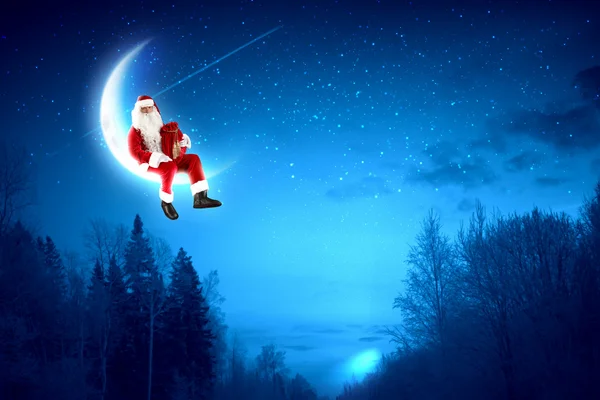 Photo of santa claus sitting on the moon — Stock Photo, Image