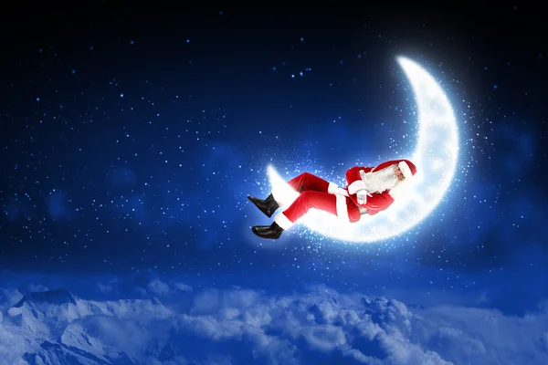 Photo of santa claus sitting on the moon — Stock Photo, Image