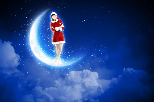 Photo of santa girl sitting on the moon — Stock Photo, Image