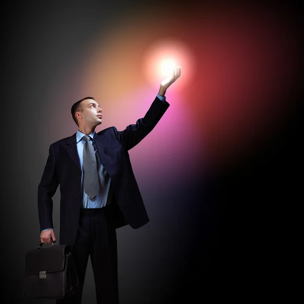 Geschäftsmann mit leuchtendem Licht — Stockfoto