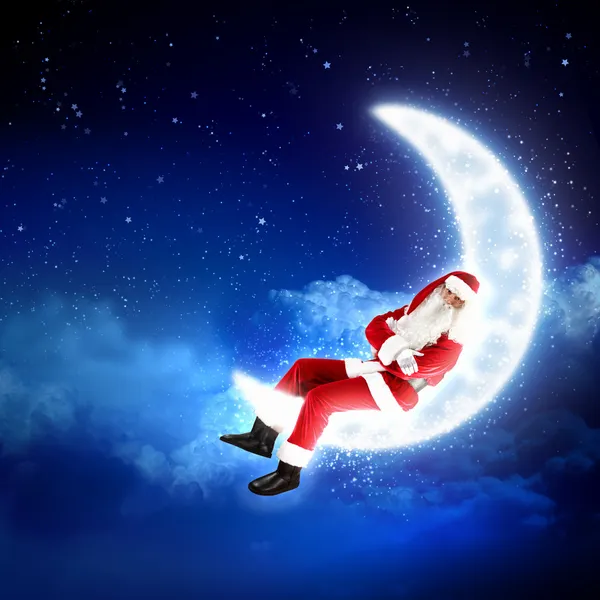 Foto Santa Claus duduk di bulan. — Stok Foto