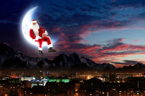 Photo of santa claus sitting on the moon — Stock Photo, Image