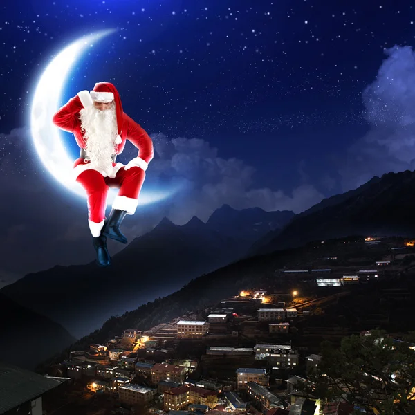 Photo of santa claus sitting on the moon — Stock Photo, Image