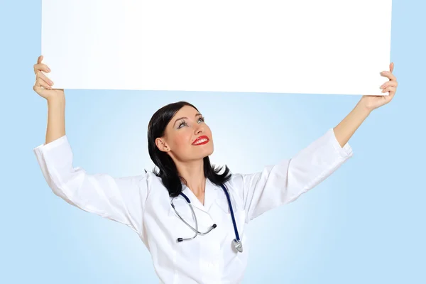 Young female doctor with a banner — Stock Photo, Image