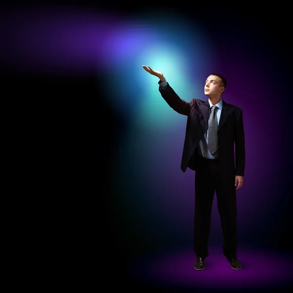 Businessman with light shining — Stock Photo, Image