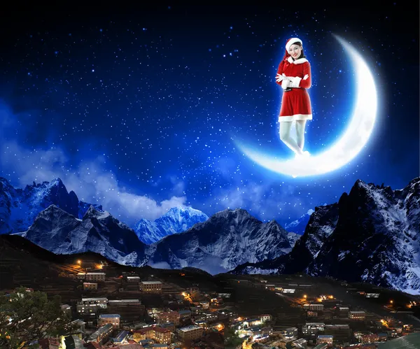 Photo of santa claus sitting on the moon — Stock Photo, Image