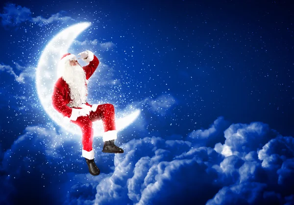 Фото Санта Клауса, що сидить на Місяці — стокове фото