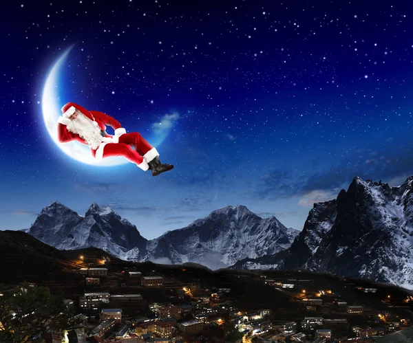 Photo of santa claus sitting on the moon — Stock Photo, Image