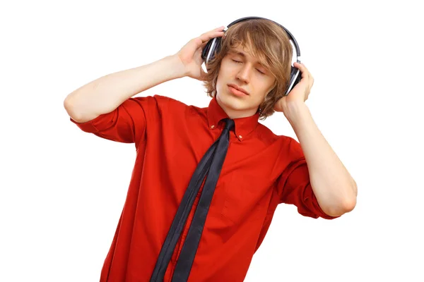 Happy smiling young man dancing and listening to music — Stock Photo, Image