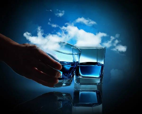 Two glasses of blue liquid against cloudy background — Stock Photo, Image