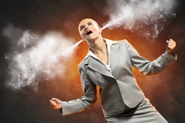 Businesswoman in anger screaming steam going out from ears — Stock Photo, Image