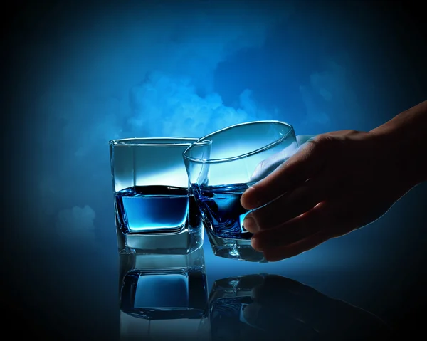 Zwei Gläser blaue Flüssigkeit vor trübem Hintergrund — Stockfoto