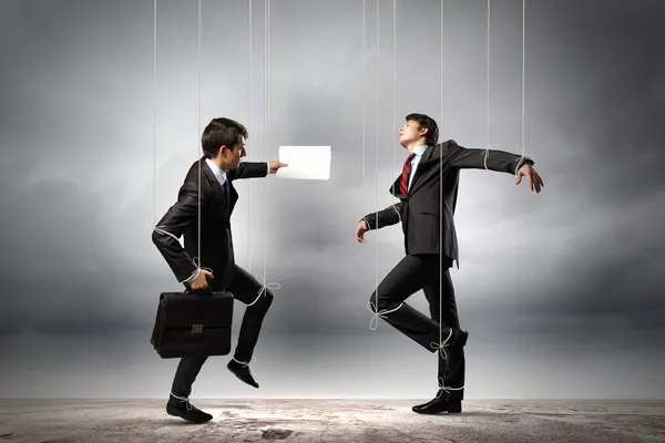 Image of businesspeople hanging on strings like marionettes. — Stock Photo, Image