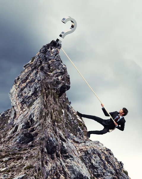 Businessman climbing mountain — Stock Photo, Image