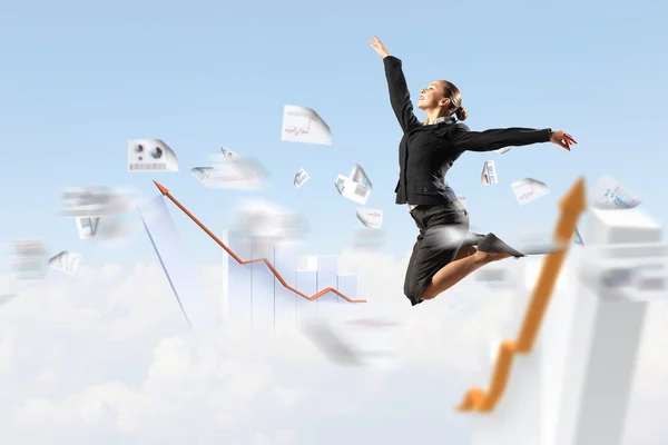 Businesswoman in black suit jumping — Stock Photo, Image