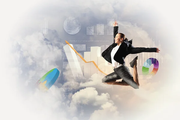 Businesswoman in black suit jumping — Stock Photo, Image