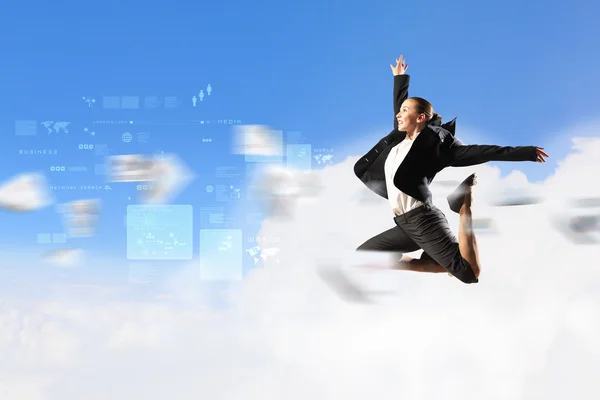 Businesswoman in black suit jumping — Stock Photo, Image