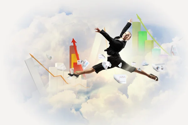 Businesswoman in black suit jumping — Stock Photo, Image