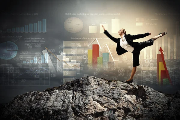 Businesswoman standing atop of mountain — Stock Photo, Image