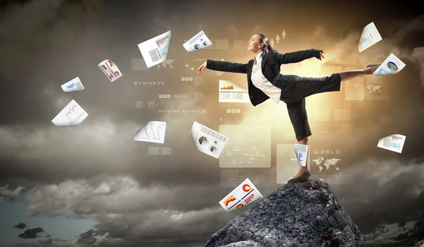 Businesswoman standing atop of mountain — Stock Photo, Image